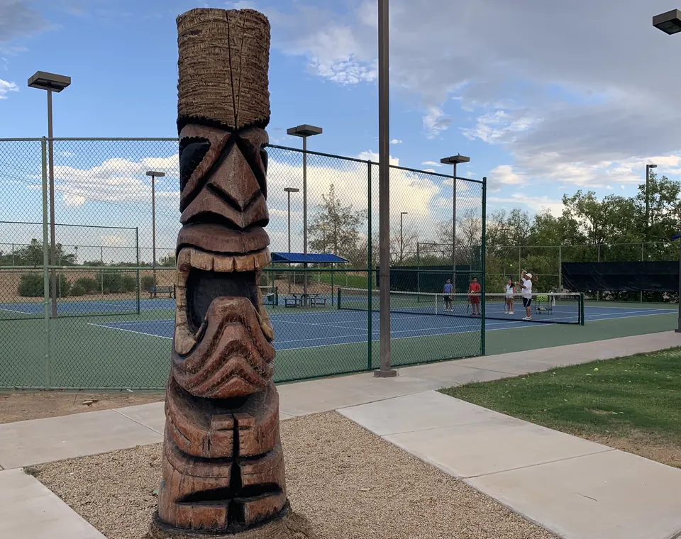 Kachina statues watching tennis